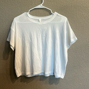 White classic cotton top from lululemon. Size 8 never worn. Tags taken off.